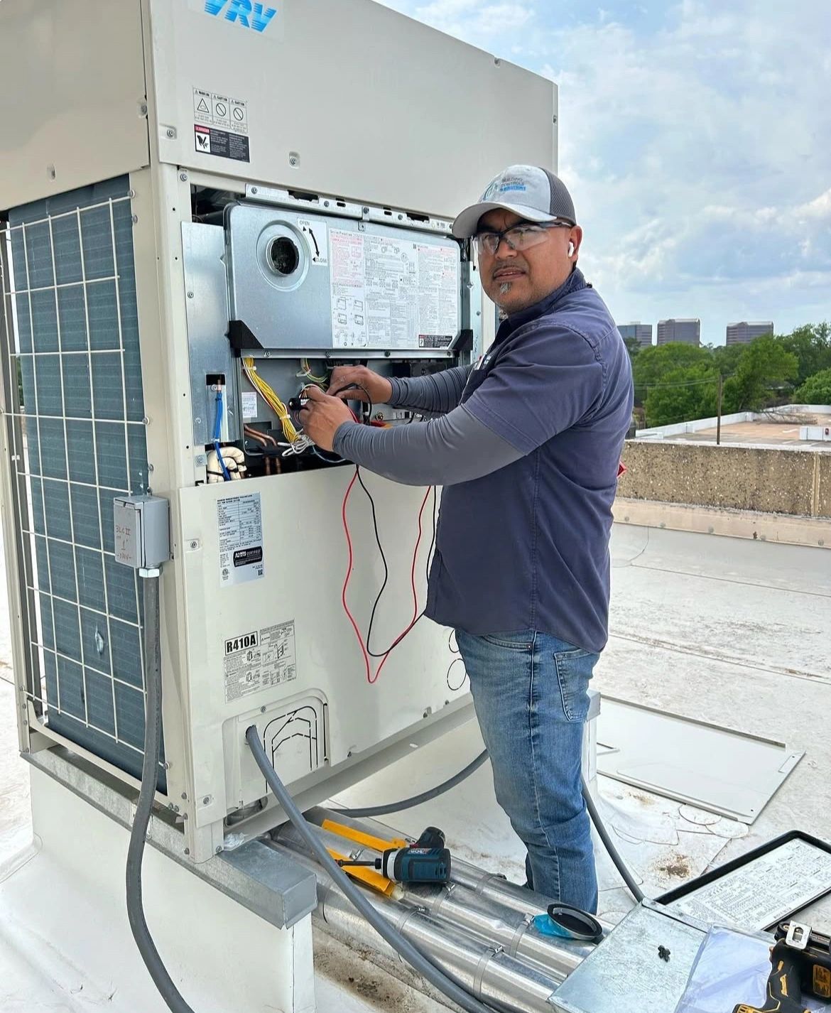 Strong Village technician diagnosing a commercial rooftop HVAC unit